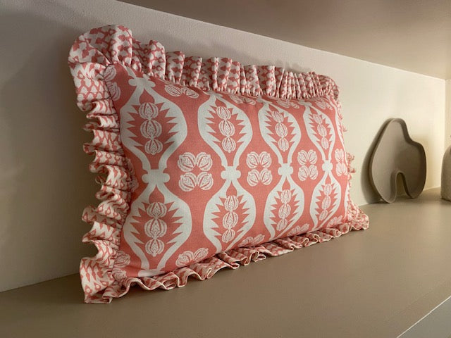 pink frilly cushion on shelf