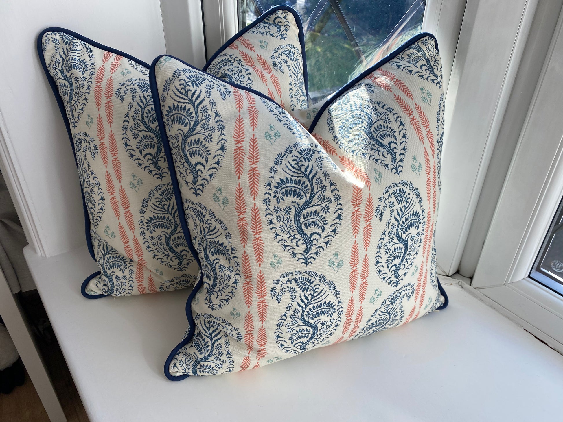 Handmade luxury cushion in blue and coral with piping The Cushion Atelier