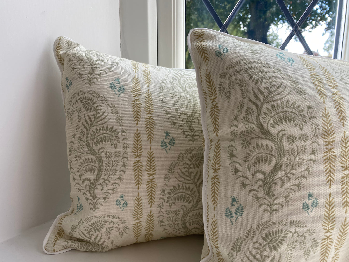 Larisa fabric sage and gold cotton piped cushions close up