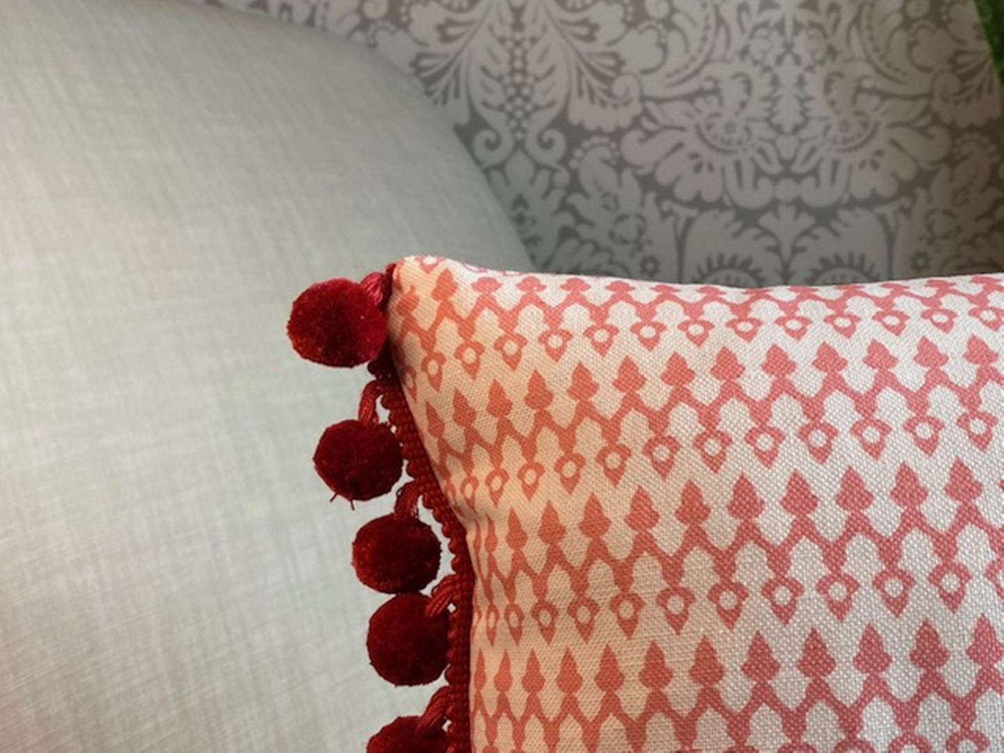 Tea4Two fabric red cotton cushion with red pompom trim close up