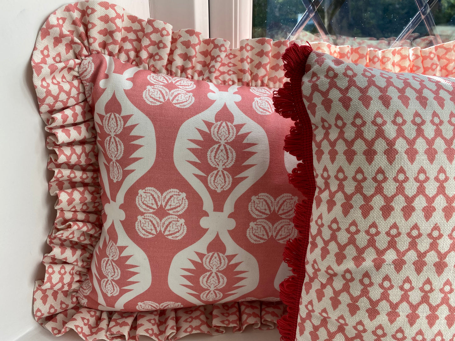 pink frilly cushion and pink cushion with red fan trim
